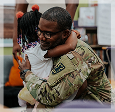 male soldier hugging child